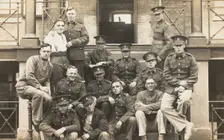 Soldiers posing for a group portrait outside a large building, c1910s. Creator: Unknown
