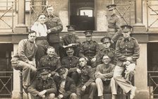 Soldiers posing for a group portrait outside a large building, c1910s. Creator: Unknown