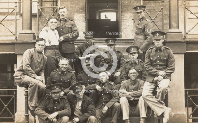 Soldiers posing for a group portrait outside a large building, c1910s. Creator: Unknown.