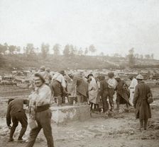 Soldiers queuing in the mud for water, Genicourt, northern France, c1914-c1918