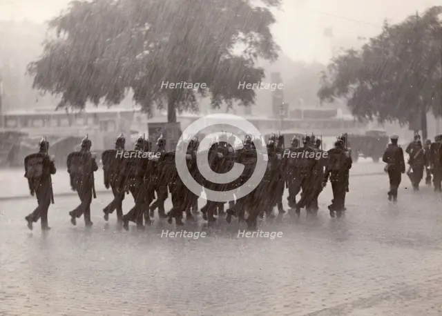 Soldiers returning to their base in a cloudburst, Stockholm, Sweden, 1934. Creator: Karl Sandels.