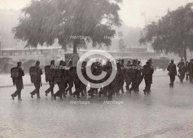 Soldiers returning to their base in a cloudburst, Stockholm, Sweden, 1934. Artist: Karl Sandels