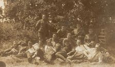 Soldiers relaxing in a field, (between 1910 and 1919?). Creator: Unknown