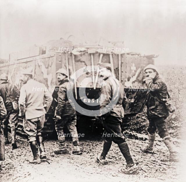 Soldiers walking behind tank, c1914-c1918.  Artist: Unknown.