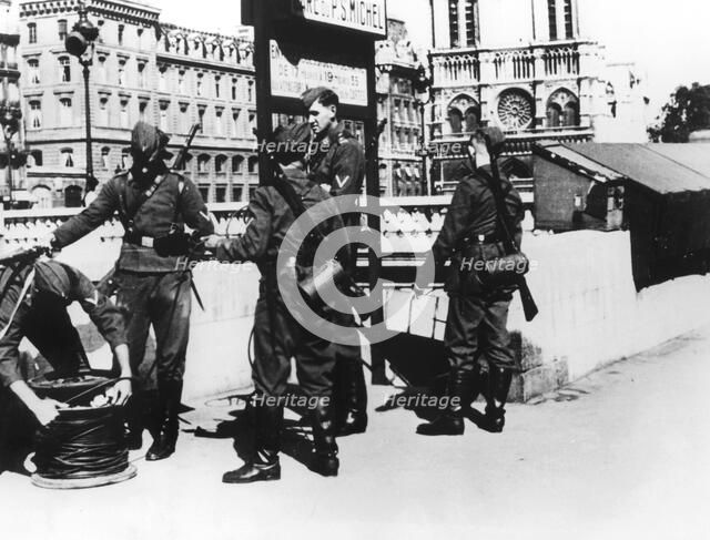 Soldiers with a telephone cable on the Pont St Michel, Paris, June 1940. Artist: Unknown