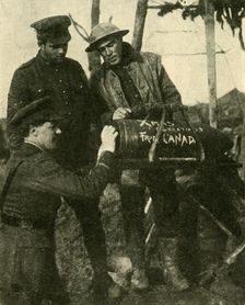 Soldiers write Christmas greetings on a shell, Western Front, First World War, c1916, (c1920). Creator: Unknown