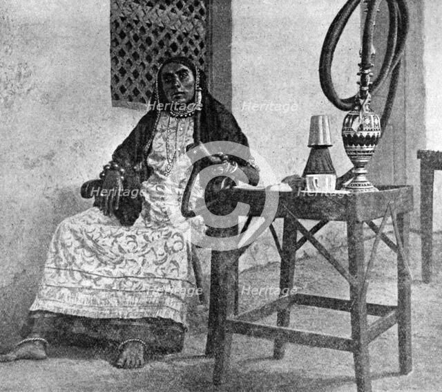 Somali woman smoking a hookah, Aden, 1922. Artist: Unknown
