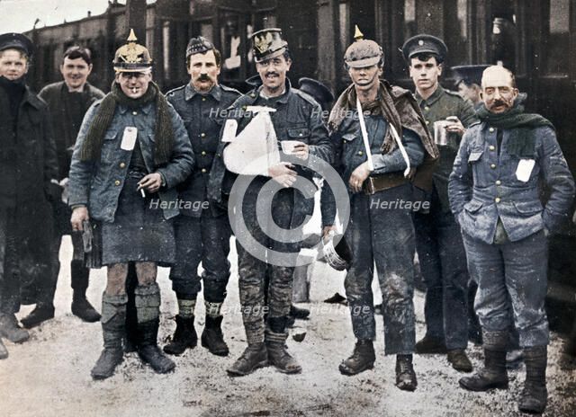 Some cheerful wounded from the Neuve Chapelle fighting, wearing captured German helmets, 1915. Artist: Unknown.