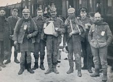 Some cheerful wounded from the Neuve Chapelle fighting, wearing captured German helmets, 1915