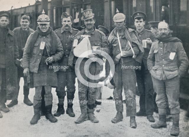 Some cheerful wounded from the Neuve Chapelle fighting, wearing captured German helmets, 1915. Artist: Unknown