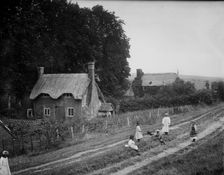Some children playing with a dog on a rutted track, West Ilsley, West Berkshire, 1900. Creator: Henry Taunt