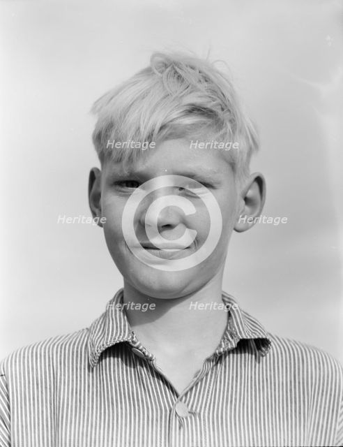 Son of migratory worker from Kansas in squatters' camp near Farmersville, California, 1936. Creator: Dorothea Lange.