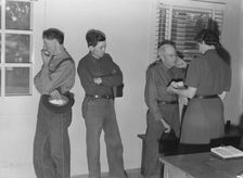 Sons, migratory workers, bring father...to the camp clinic, FSA camp, Tulare County, CA, 1939. Creator: Dorothea Lange