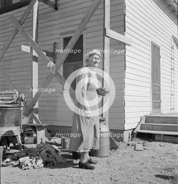 Soper grandmother helps the large family, Willow Creek area, Malheur County, Oregon, 1939. Creator: Dorothea Lange.