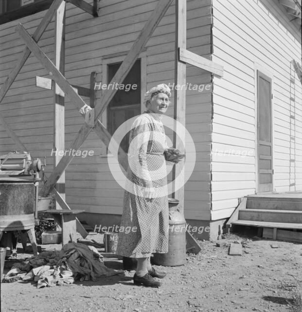 Soper grandmother helps the large family, Willow Creek area, Malheur County, Oregon, 1939. Creator: Dorothea Lange.
