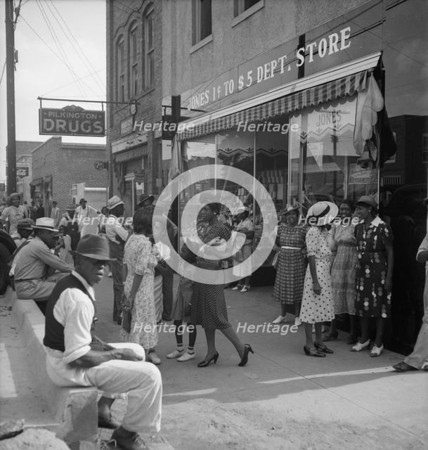 Saturday afternoon - shopping and visiting on main street of Pittsboro, North Carolina, 1939. Creator: Dorothea Lange.
