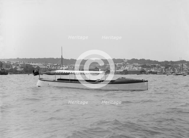 Saunders' motor launch at anchor, 1914. Creator: Kirk & Sons of Cowes.