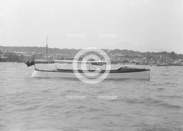 Saunders' motor launch at anchor, 1914. Creator: Kirk & Sons of Cowes.