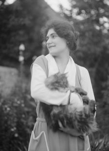 Savagoy, Henriette, with cat, outdoors, 1922 July 31. Creator: Arnold Genthe