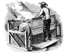 Saw gin for cleaning cotton being operated by barefoot black labourer, southern USA, 1865