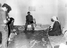 Saddam Hussein visiting a peasant house in Basra, Iraq, 1987