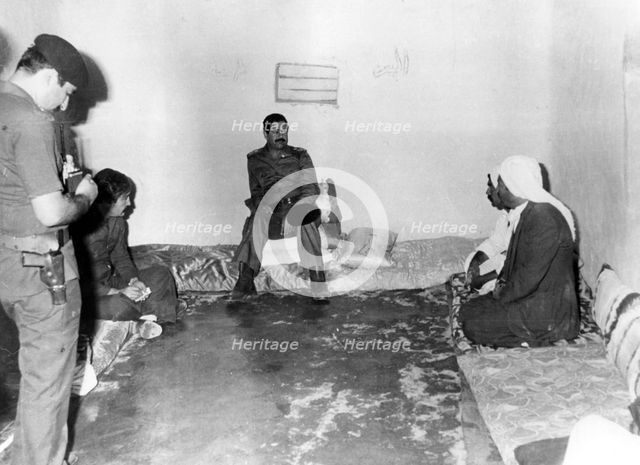 Saddam Hussein visiting a peasant house in Basra, Iraq, 1987. Artist: Unknown