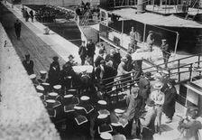 Sailors taking children in coffins from LADY GREY at Quebec, 1914. Creator: Bain News Service