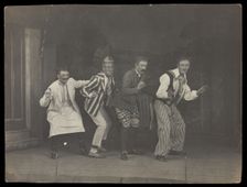 Sailors on stage in mid-pose, wearing a variety of costumes, [between 1910 and 1919?]. Creator: Unknown