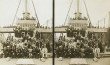 Sailors, probably American, and some civilians posed on a cruiser berthed in New York(?), c1905. Creator: Underwood & Underwood