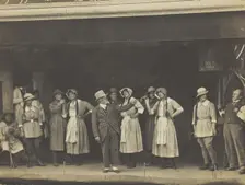 Sailors, some in drag, stand on stage performing a scene, (between 1910 and 1919?). Creator: Unknown