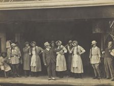 Sailors, some in drag, stand on stage performing a scene, (between 1910 and 1919?). Creator: Unknown