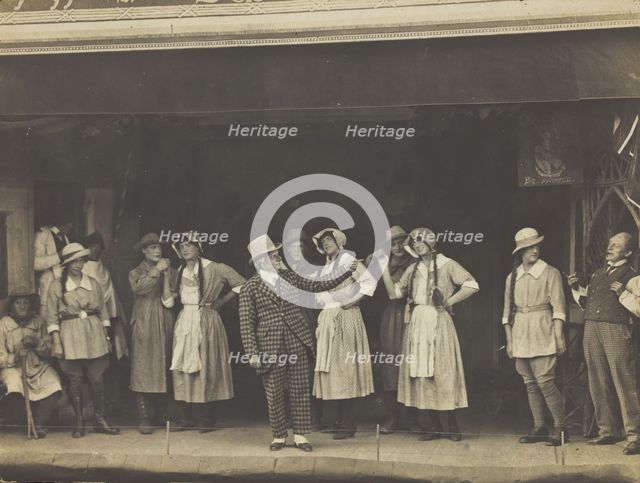 Sailors, some in drag, stand on stage performing a scene, (between 1910 and 1919?). Creator: Unknown.