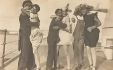Sailors, some in drag, pose as three couples on the deck of a ship, (between 1920 and 1929?). Creator: Unknown