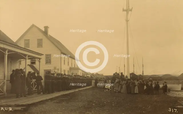 Sailors standing in line on boardwalk with a group of local women and men standing..., 1894 or 1895. Creator: Alfred Lee Broadbent.