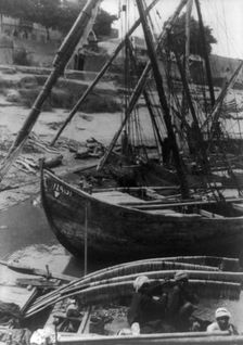Sailboats and natives at shore, Egypt?, between 1910 and 1925. Creator: Frances Benjamin Johnston