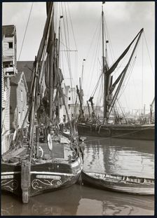 Sailed fishing vessels moored beside timber warehouses at Rochester, Medway, 1925-1935. Creator: J Dixon Scott