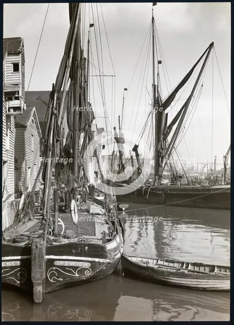 Sailed fishing vessels moored beside timber warehouses at Rochester, Medway, 1925-1935. Creator: J Dixon Scott.