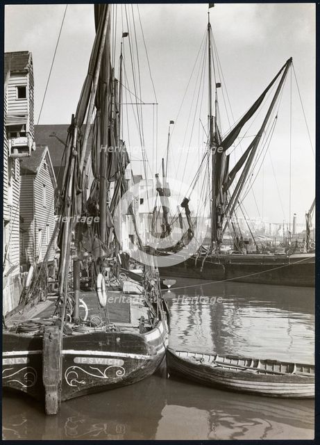 Sailed fishing vessels moored beside timber warehouses at Rochester, Medway, 1925-1935. Creator: J Dixon Scott.