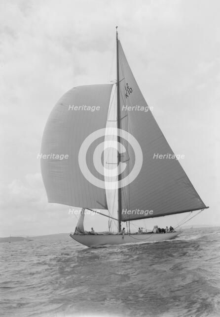 Sailing yacht 'Trivia' running downwind under spinnaker, 1939. Creator: Kirk & Sons of Cowes.
