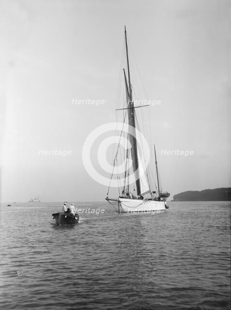 Sailing yacht 'Bona' being towed, 1912. Creator: Kirk & Sons of Cowes.