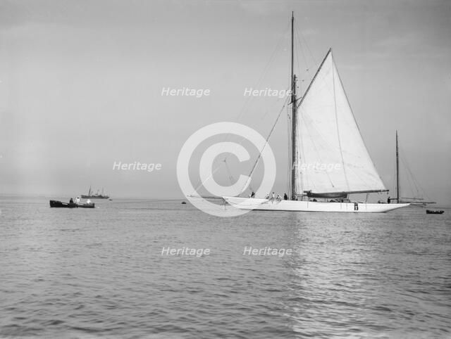 Sailing yacht 'Bona' being towed, 1912. Creator: Kirk & Sons of Cowes.