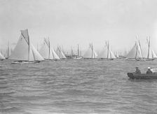 Sailing yachts cross start line. Creator: Kirk & Sons of Cowes