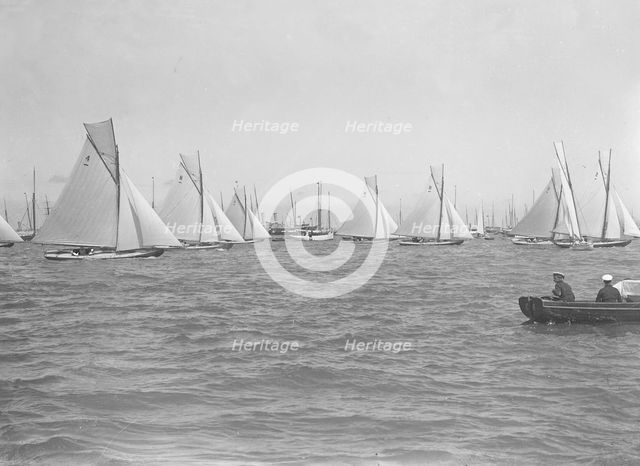 Sailing yachts cross start line. Creator: Kirk & Sons of Cowes.