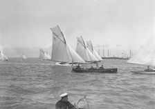 Sailing yachts cross start line. Creator: Kirk & Sons of Cowes