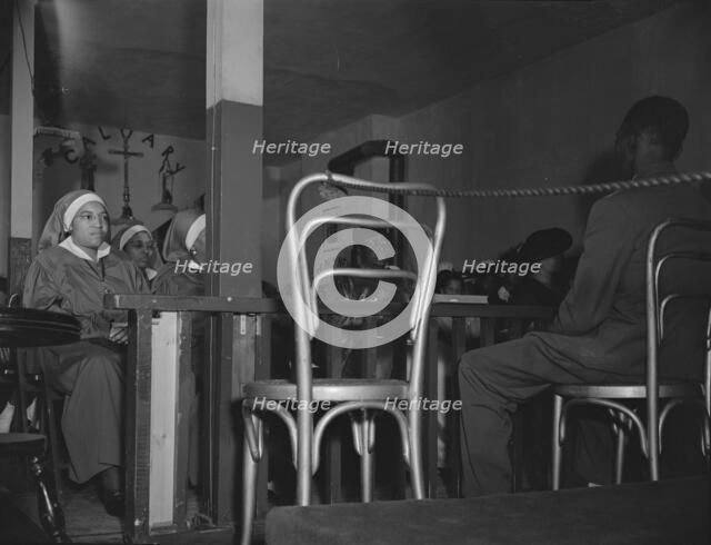 "Saints" in the congregation of the St. Martin's Spiritual Church, Washington, D.C., 1942. Creator: Gordon Parks.