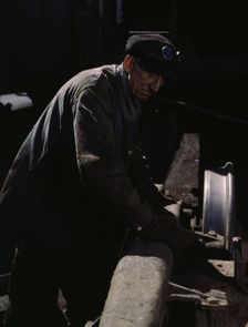 Sam Cell, working on the truck of a car..., C & NW RR's Proviso yard, Chicago, Ill., 1943. Creator: Jack Delano