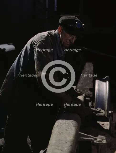 Sam Cell, working on the truck of a car..., C & NW RR's Proviso yard, Chicago, Ill., 1943. Creator: Jack Delano.