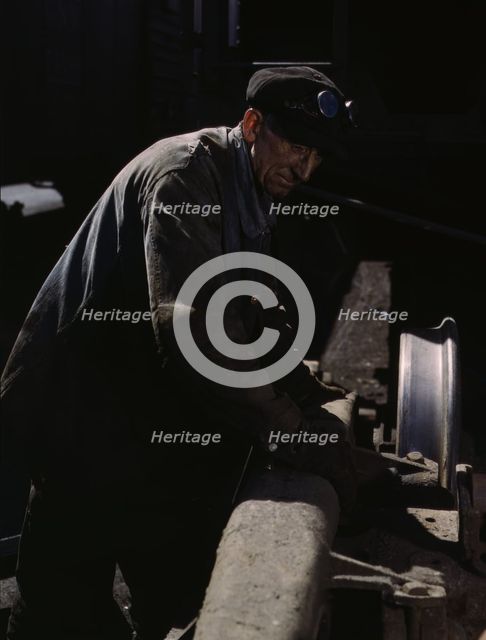 Sam Cell, working on the truck of a car..., C & NW RR's Proviso yard, Chicago, Ill., 1943. Creator: Jack Delano.