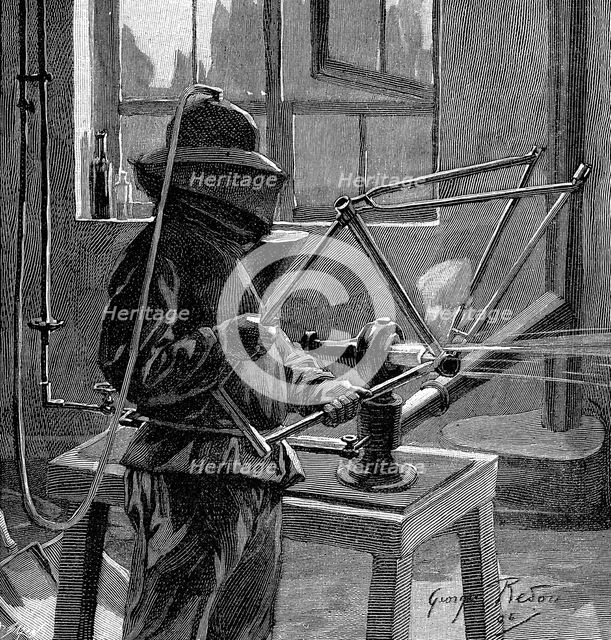 Sandblasting the joints of a bicycle frame, France, 1896. Creator: Unknown.