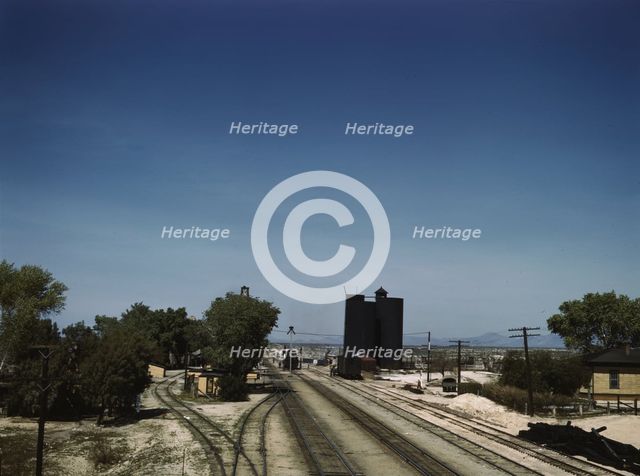 Santa Fe R.R. going through Yucca, Arizona; a watering and refueling stop, 1943. Creator: Jack Delano.